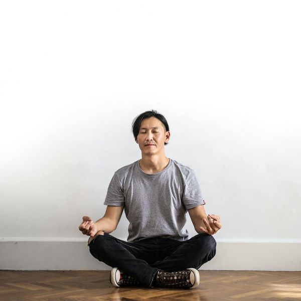 Man sitting in a calm meditation pose, representing mental clarity and focus.
